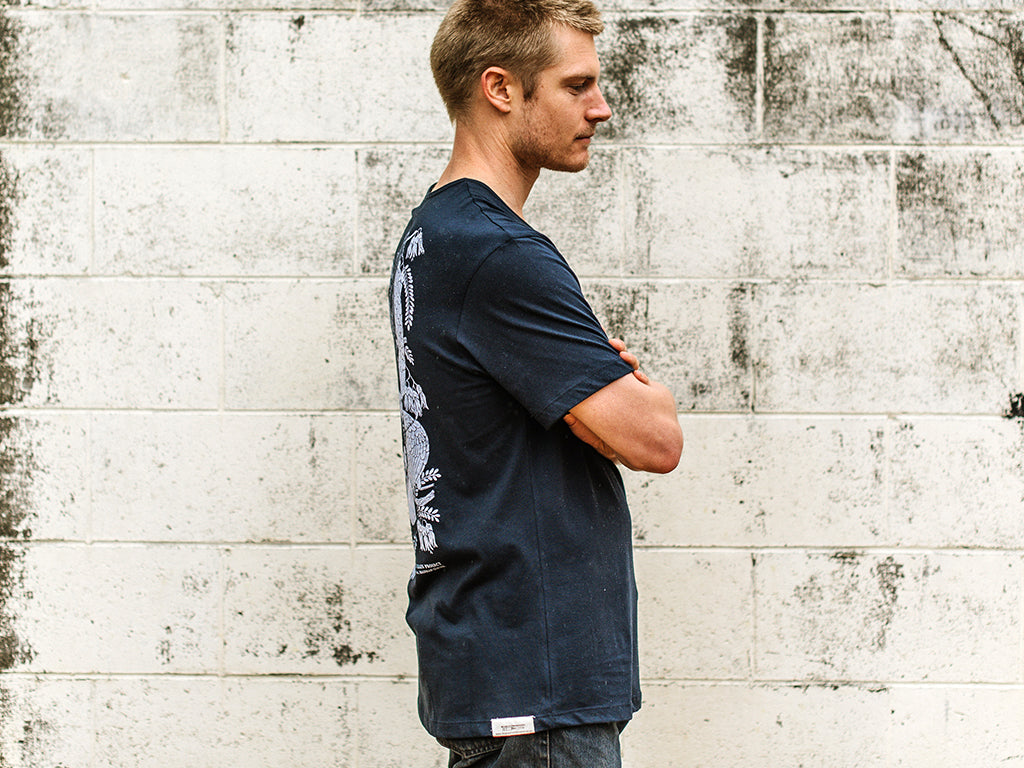 Side of Men's Waka Huia navy T-shirt with design by Hannah Jensen. Organic cotton fair trade tee, hand screen printed by The Paper Rain Project in Marlborough New Zealand